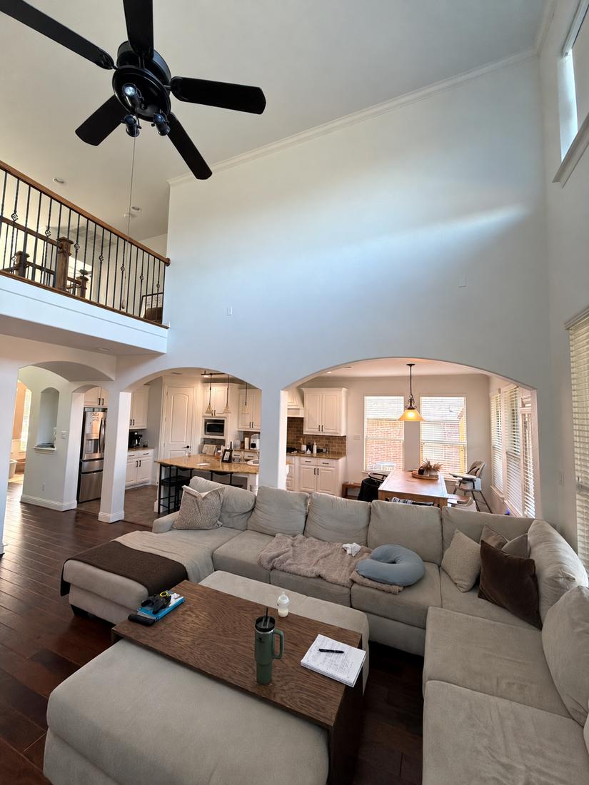Living room before remodel, with arched openings into a closed-off kitchen