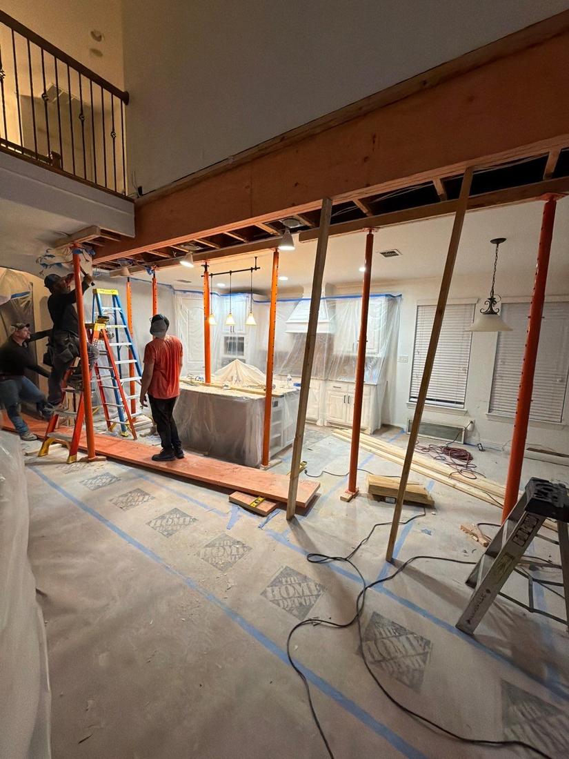 Crew removing the wall and arches with temporary supports under the loft